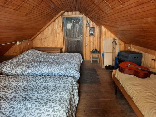 a bedroom with two beds and a suitcase in it at La Baita di Heidi in Craveggia