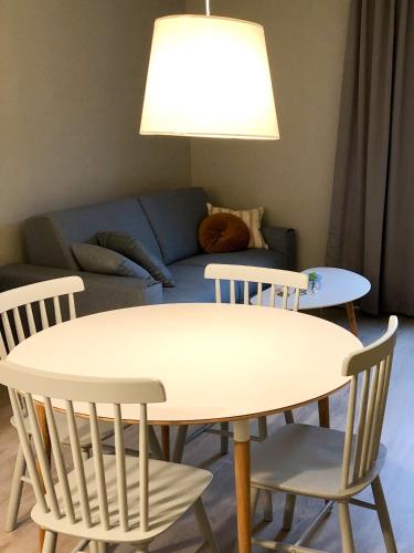 a table and chairs in a living room with a couch at Hotell Nyboholm in Ulricehamn