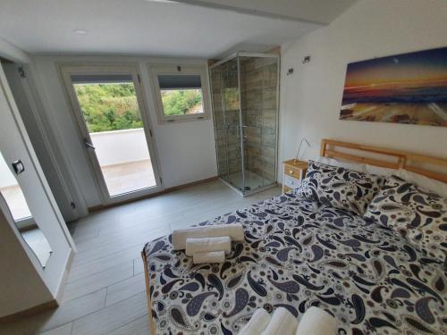 a bedroom with a large bed and a shower at Il Daviduccio ibla in Ragusa