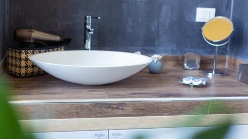 a bathroom with a large white bowl sink on a counter at Turenum Apartment B&B in Trani