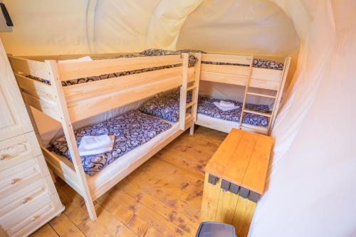 a room with two bunk beds and a table at Ranč pod Ostrou Skalou in Stratená