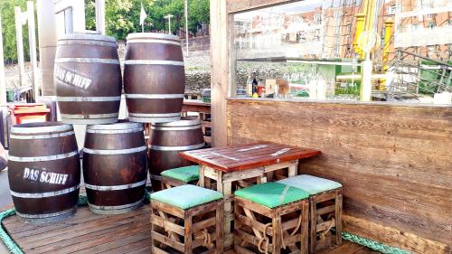 a table and chairs and barrels on a porch at Alexander von Humboldt - Das Schiff in Bremen