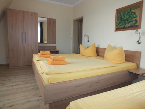 a bedroom with two beds with towels on them at Pension am Elberadweg in Radebeul