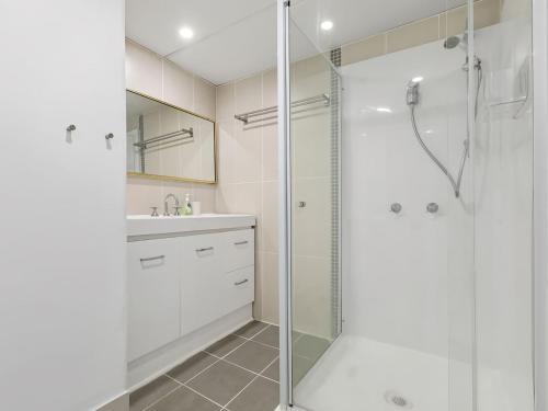 a bathroom with a shower and a sink at Kingy Beach Getaway with Balcony - Central Kingscliff in Kingscliff