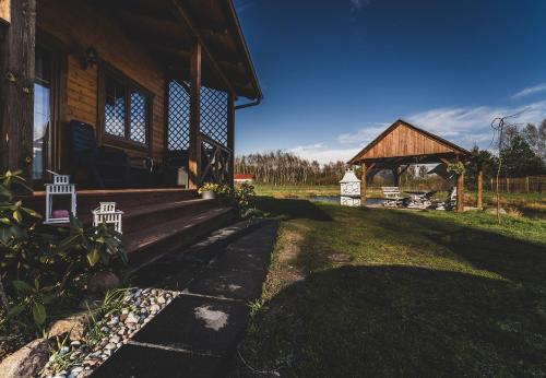 a house with a porch and a barn at Kaszuby wczasy u Danusi sauna i bania in Lipusz