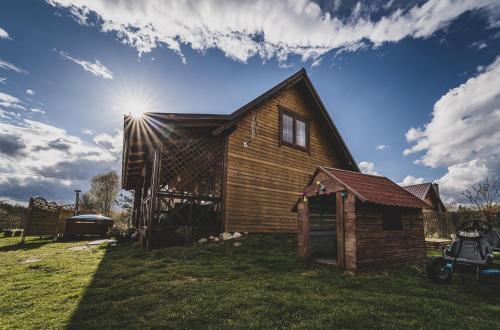a wooden house with the sun in the sky at Kaszuby wczasy u Danusi sauna i bania in Lipusz