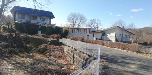 a house on the side of a road with a fence at Suijin Hotel - Vacation STAY 23120v in Chichibu