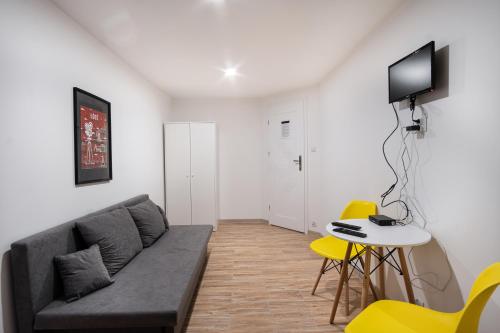 a living room with a couch and a table at Revolution Aparts - Rewolucji 27 in Łódź