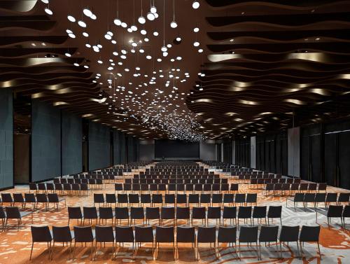 a large hall with chairs and a large chandelier at Hyatt Regency Shanghai Songjiang in Songjiang