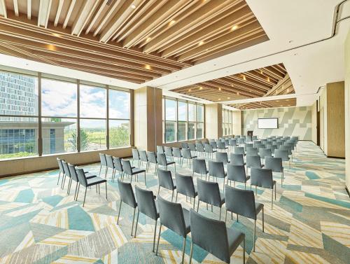 a conference room with chairs and a podium in it at Hyatt Regency Shanghai Songjiang in Songjiang