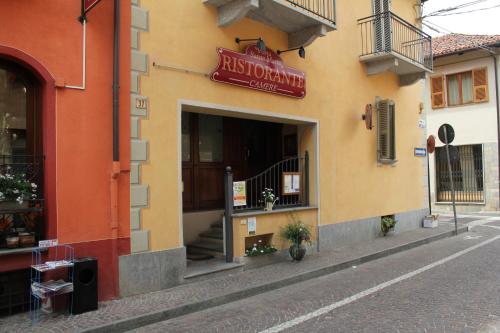 a building with a sign for a restaurant on a street at Hotel Porta Santa Maria in Busca