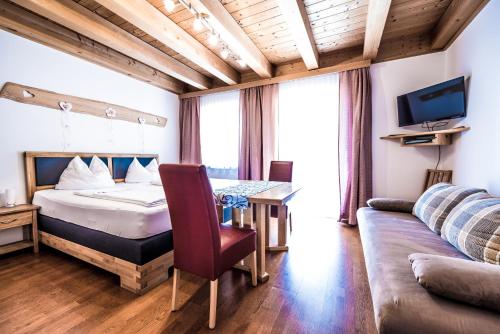 a bedroom with a bed and a table and a couch at Obermayrgut in Gallspach
