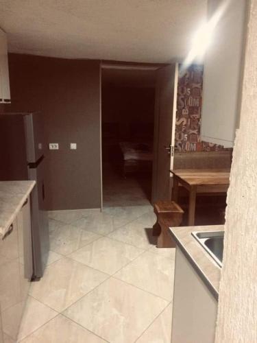 a kitchen with a sink and a table in it at Guesthouse Raisa in Kvareli