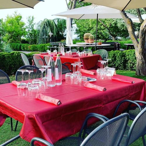 a table with red table cloth and wine glasses at Hotel Tetto delle Marche - Ristorante dei Conti in Cingoli