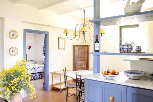 a kitchen with a table and a room with a bed at Poggio alle Vigne in Torgiano