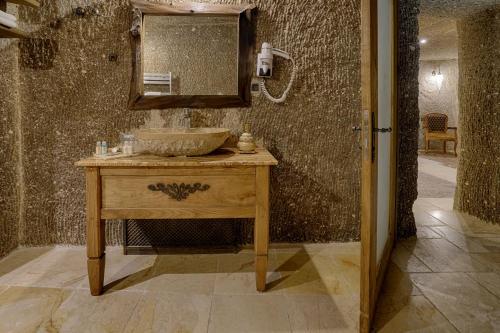 a bathroom with a sink and a mirror at Hera Cave Suites in Goreme