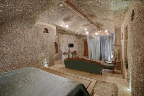 a bedroom with a bed in a stone room at Hera Cave Suites in Goreme