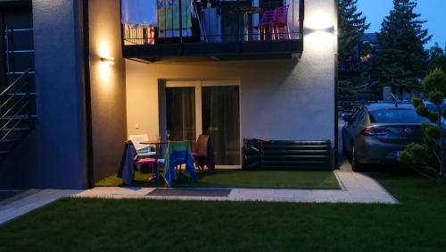 a house with a table and chairs in the yard at Anna Villa Füred Boutique Rooms in Balatonfüred