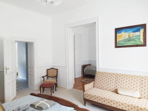 a living room with a couch and two chairs at Atelier Keszthely Center in Keszthely