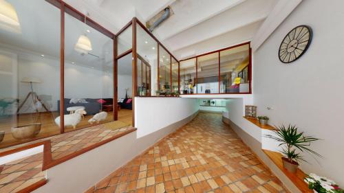 a hallway of a house with a clock on the wall at Lycklama Loft in Cannes