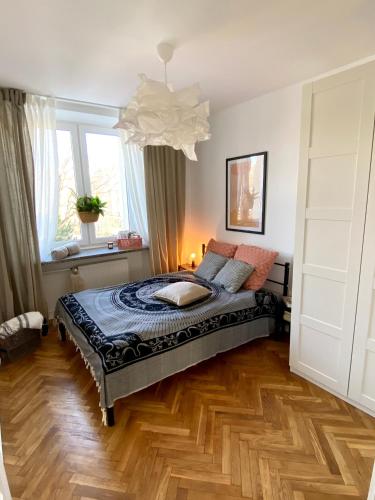 a bedroom with a bed and a large window at Apartament Jan III Sobieski in Rzeszów