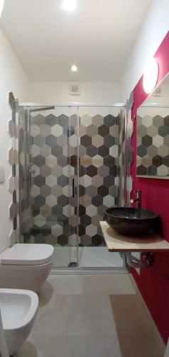 a bathroom with a sink and a toilet and a shower at Bed and Breakfast il Pesciolino in Trani