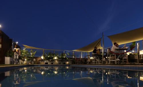people sitting at tables by a pool at night at Le Palace d'Anfa in Casablanca