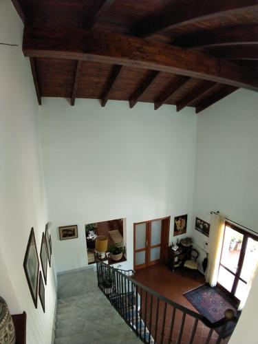 a living room with wooden ceilings and a staircase at Il Pagio in Alghero