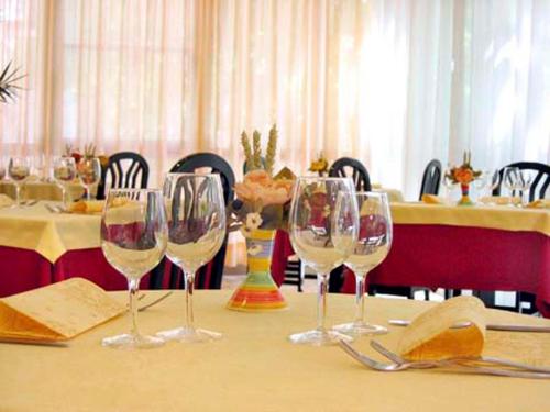 a group of wine glasses sitting on a table at Hotel Busignani in Rimini