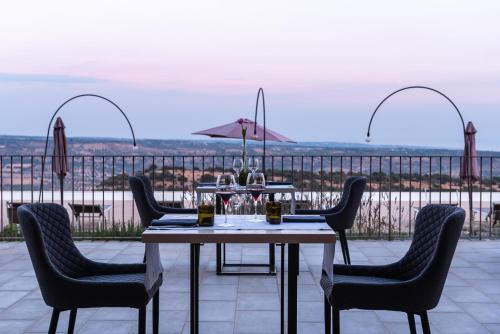 a table and chairs on a patio with a view at Relais Chiaramonte in Ragusa