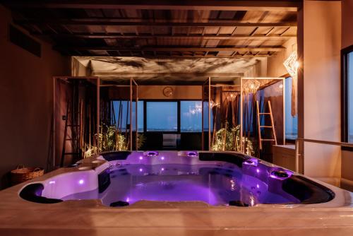 a purple bath tub in a room with a window at Relais Chiaramonte in Ragusa