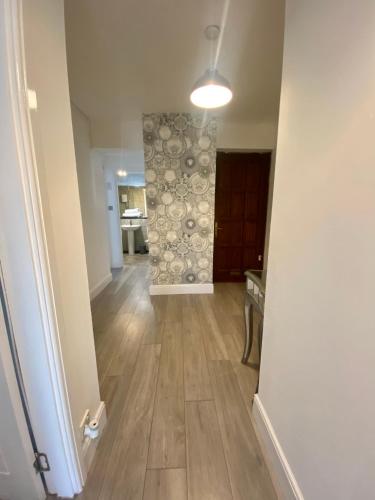 an empty room with a hallway with wood floors at 2 Bedroom Apartment at SECC Hydro FREE PARKING in Glasgow