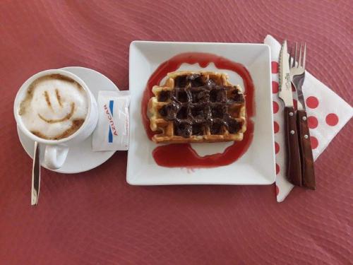 un plato de gofres y una taza de café en Hotel Plateros, en Córdoba
