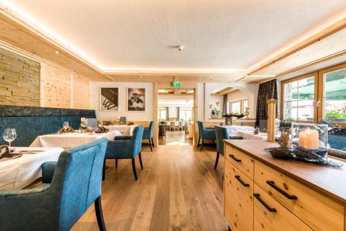 a dining room with tables and chairs in a restaurant at Wohlfühlhotel Berg Heil in Holzgau
