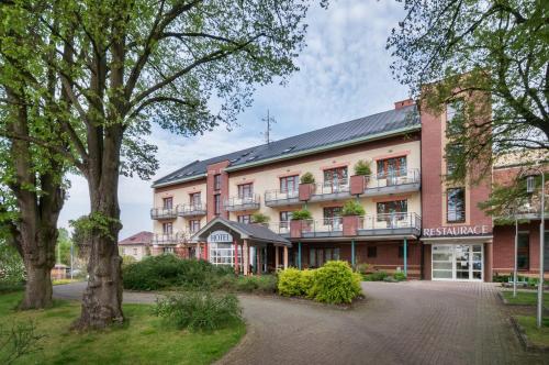 an exterior view of a building with trees at April hotel Panorama in Rychnov nad Kněžnou
