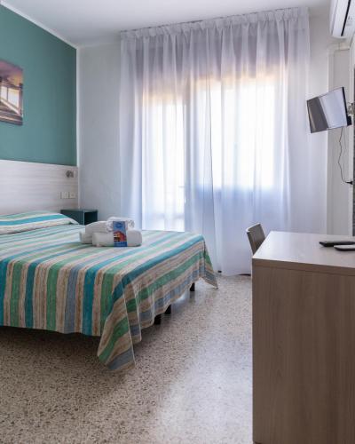 Postel nebo postele na pokoji v ubytování Hotel Laura