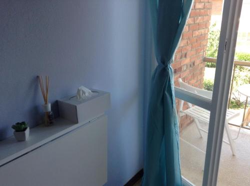 a room with a blue wall and a window at Il Pescatore in Marina di Pisa