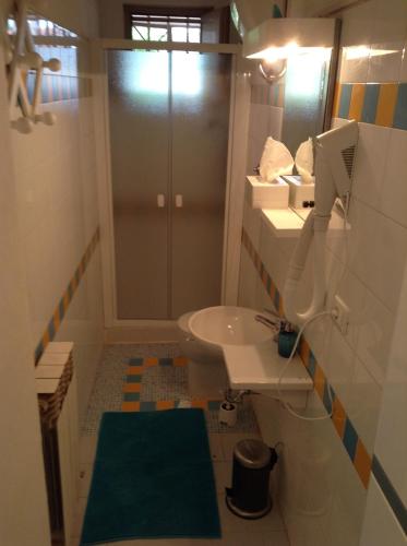 a bathroom with a sink and a toilet and a mirror at Il Pescatore in Marina di Pisa