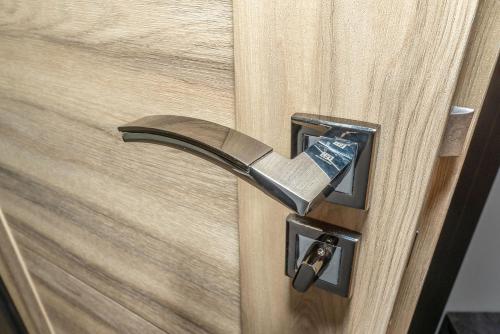 a close up of a wooden door with a door knob at Arany Apartman Miskolc in Miskolc