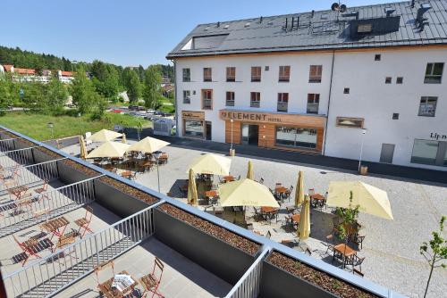 an aerial view of a hotel with tables and umbrellas at Hotel Element in Lipno nad Vltavou