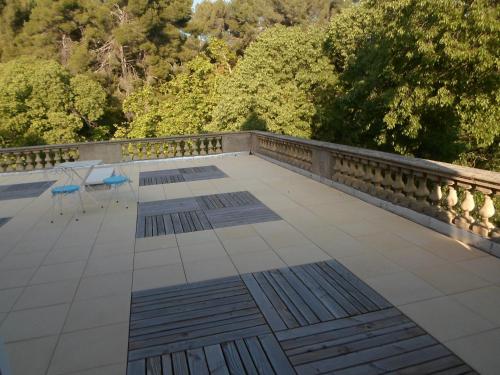 a balcony with a table and chairs on a bridge at Pavillon de Beauregard in Aix-en-Provence