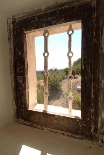 an old window with a view of a field at Pavillon de Beauregard in Aix-en-Provence