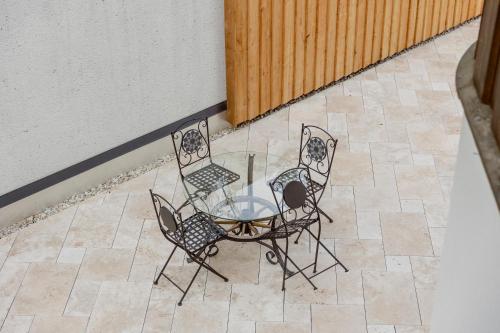two chairs and a glass table on a patio at Zur Nandl in St. Wolfgang