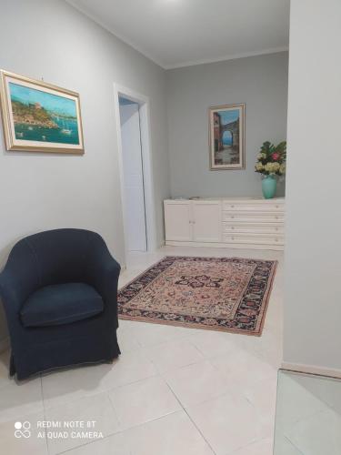 a living room with a chair and a rug at Prie De Mä in Genova