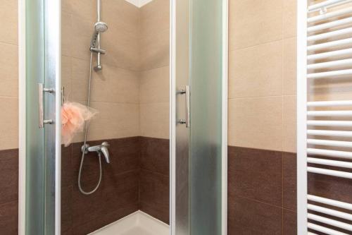 a bathroom with a shower with a glass door at Apartment Natali Punat- free parking on premises in Punat