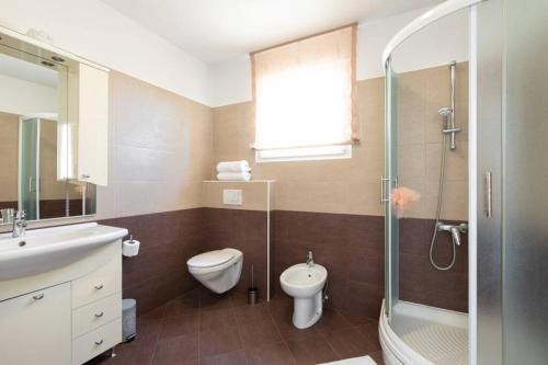 a bathroom with a toilet and a sink and a shower at Apartment Natali Punat- free parking on premises in Punat