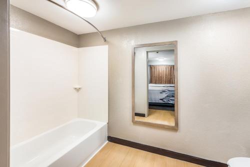 a bathroom with a bath tub and a mirror at Red Roof Inn Dayton South - Miamisburg in Miamisburg