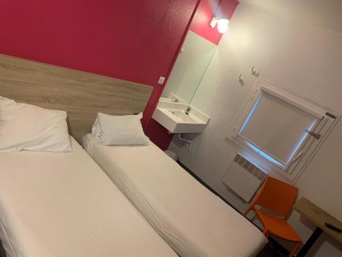 a room with two beds and a sink and a mirror at hotelF1 Villepinte Parc des Expositions in Villepinte