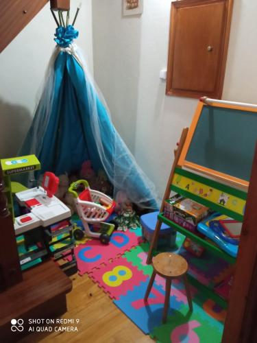 a childs play room with a tent and toys at CASA DOS GRILOS in Penacova