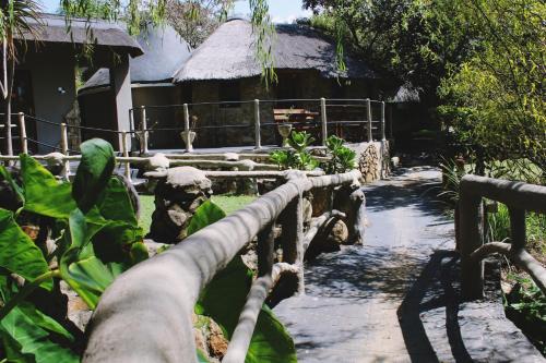 a garden with a path leading to a building at BON Hotel Rustenburg in Rustenburg